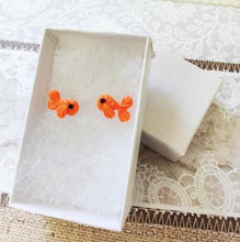 Load image into Gallery viewer, Two orange fish stud earrings in a white paper jewelry box