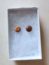 Load image into Gallery viewer, Gold and purple swirl earrings inside a white paper jewelry box