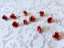 Load image into Gallery viewer, Five pairs of red and black flower shaped earrings with green metallic centers