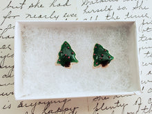 Load image into Gallery viewer, A pair of earrings made to look like sugar cookies decorated like a green Christmas tree with red sugar pearls as ornaments. The earrings are inside a white paper jewelry box.