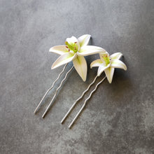 Load image into Gallery viewer, A size comparison photo of the medium and large white lily pins.