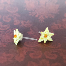 Load image into Gallery viewer, A close up of a pair of white Poinsettia earrings.
